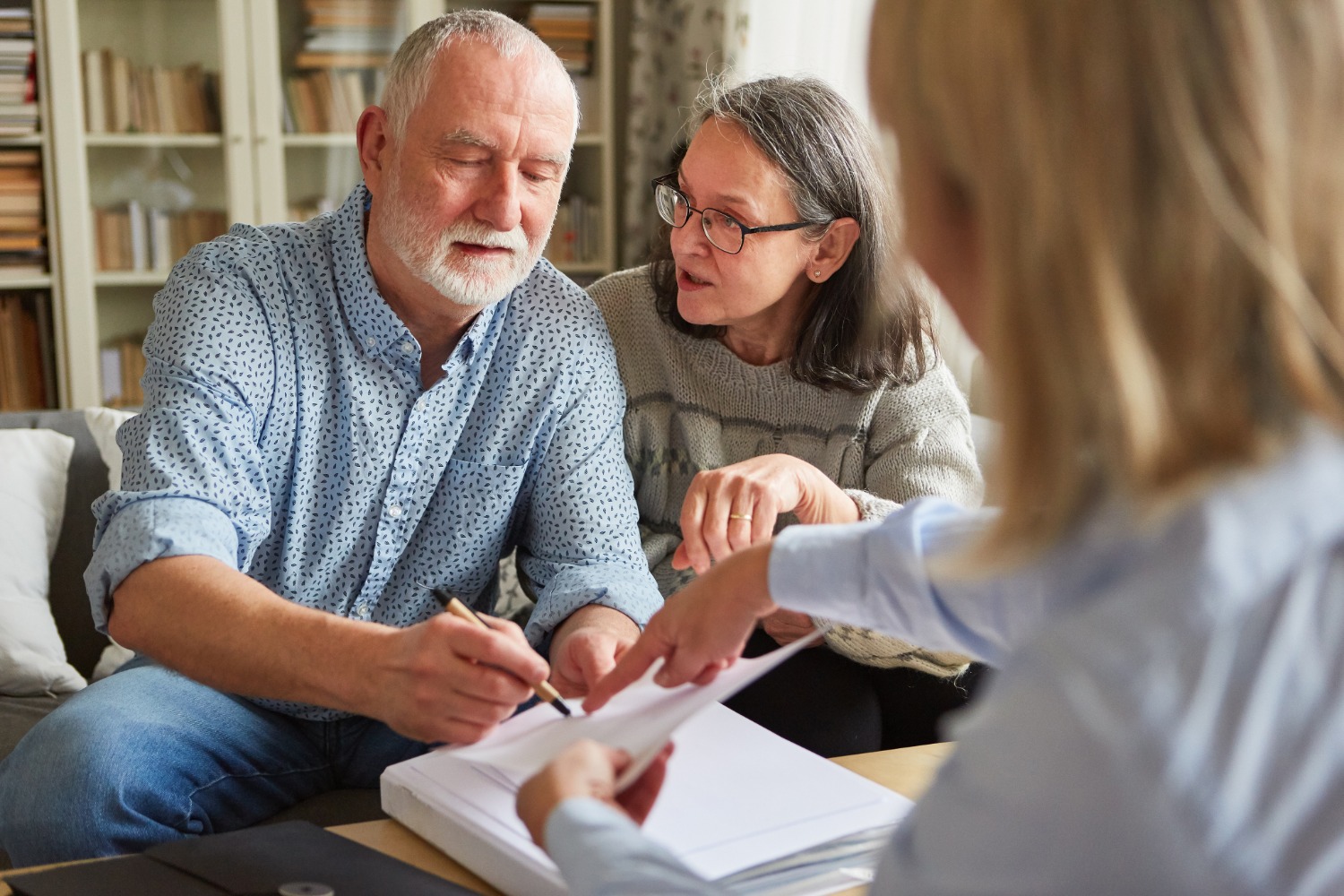Senior couple reviewing and signing their estate plan